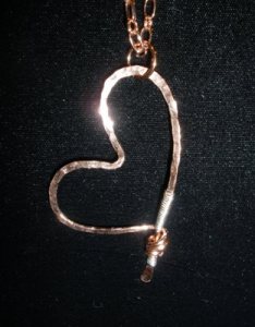 Hammered copper heart with sterling silver.